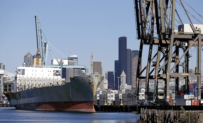 An empty container ship sits high in the water last month at the Port of Seattle. The U.S. trade deficit rose to $100.3 billion in the third quarter, according to reports. 