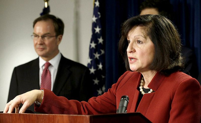 U.S. Attorney Carmen Ortiz is joined by Associate Attorney General Stuart Delery in Boston on Wednesday as she announces indictments linked to contaminated steroids made in 2012 by a Massachusetts pharmacy.