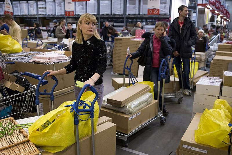 Russian consumers line up Wednesday to pay for items at an IKEA store outside Moscow, after the company warned that its prices will rise today in light of the ruble’s fall. 