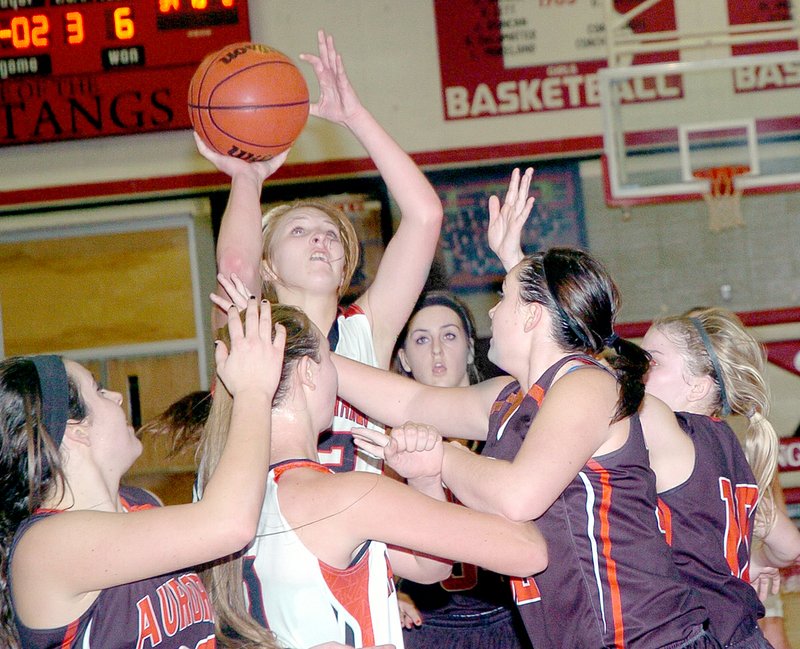 McDonald County&#8217;s Baili Nelson draws a crowd as she goes up for a shot during the Lady Mustangs&#8217; 39-36 loss Dec. 11 to Aurora.