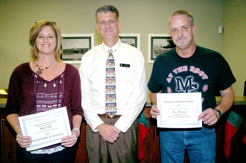 RICK PECK MCDONALD COUNTY PRESS Tim Kilby (center), principal at Noel Junior High and Elementary School, recognized Gina Tinsley (certified) and Brian Woodworth as the school&#8217;s Employees of the Month at the Dec. 11 school board meeting.