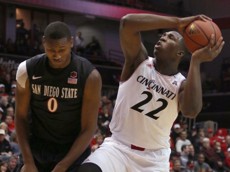 Cincinnati's Coreontae DeBerry (22) shoots past San Diego State's Skylar Spencer in the first half of their NCAA college basketball game in Cincinnati Wednesday, Dec. 17, 2014. 