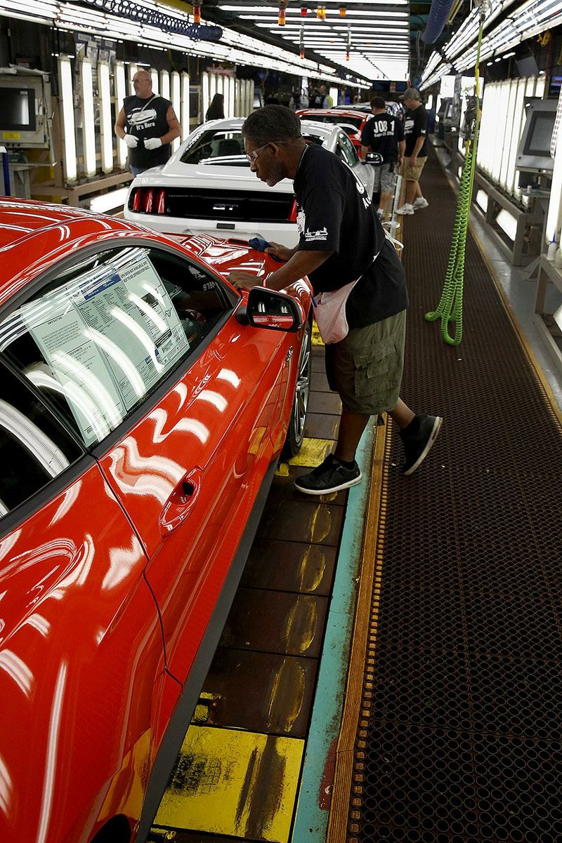 A Ford Motor Co. employee inspects a 2015 Mustang on the production line at Ford’s Flat Rock Assembly Plant in Michigan in this file photo. Ford announced a national recall that includes certain 2005 to 2008 Mustangs to replace air bags. 