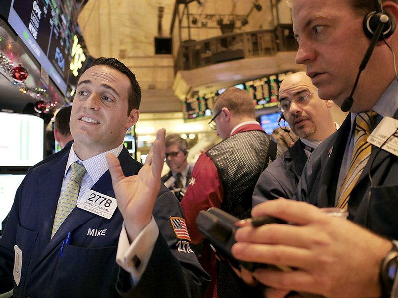 Traders watch stocks surge Thursday on the floor of the New York Stock Exchange.  