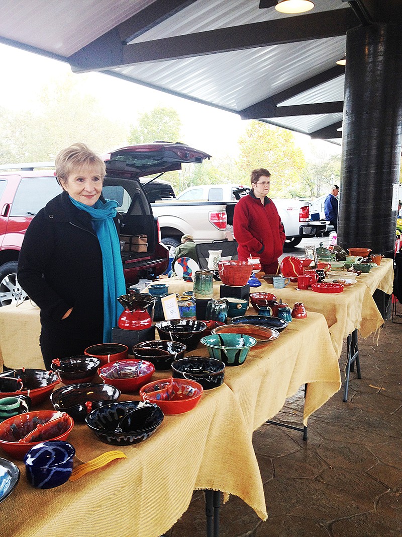 Submitted photo VENDOR: Claire Green, left, shows a variety of items that are available at the Hot Springs Farmers & Artisans Market.