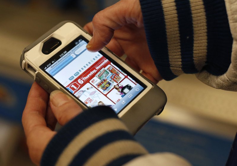 The Associated Press SHOP SMART: A Target shopper uses her iPhone to compare prices at Wal-Mart while shopping after midnight in South Portland, Maine. Increasingly, buying products online is like trading stocks: you can buy a copper mug or a coat and then hours - or even minutes later - it can go up and down in price.
