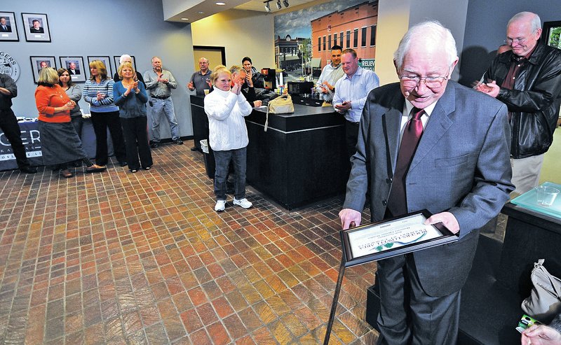 Staff Photo J.T. Wampler Bob Goodwin gets a round of applause Thursday during a reception for the retiring Rogers city councilman.