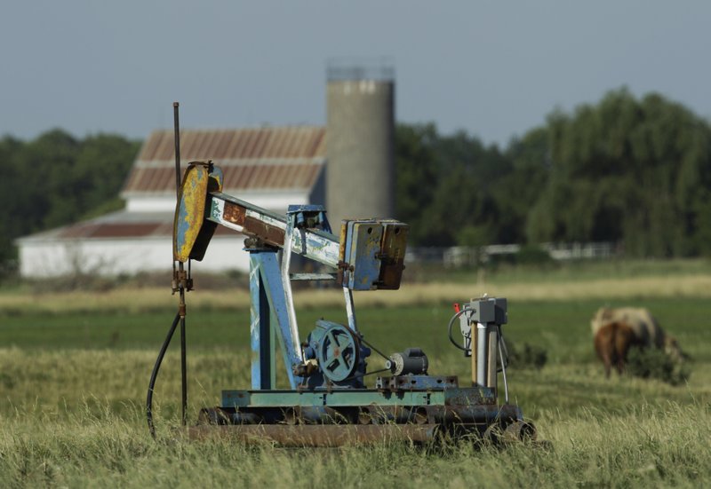 In this July 1, 2011 file photo, an oil well pumps in a pasture near Rantoul, Kan., Friday, July 1, 2011. Plunging crude prices are hitting oil producers especially hard in places like Kansas, where the industry is dominated by smaller, independent operators who depend more heavily on the cash flow from producing wells to pay for drilling new ones. 