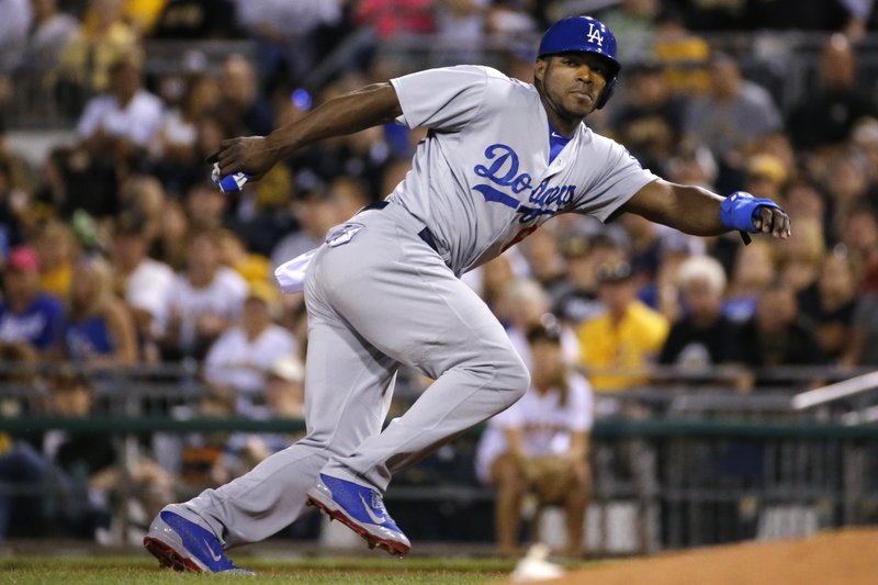 In this July 23, 2014, file photo, Los Angeles Dodgers' Yasiel Puig leads off first during a baseball game against the Pittsburgh Pirates in Pittsburgh. Twenty-five Cuban-born players appeared in the major leagues this year, a group that includes outfielders Puig and Yoenys Cespedes, and hard-throwing reliever Aroldis Chapman. Fred Claire can see the day when Major League Baseball teams open academies for prospects in Cuba. "It's absolutely a natural, just as the Dominican was and Venezuela. You go to where the talent is," the former Los Angeles Dodgers general manager said Wednesday, Dec. 17, 2014. "The high talent level for Cuban players is still there."