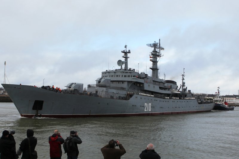 Residents watch the Russian navy ship Smolny, with about 400 Russian sailors aboard,  leaving the port of Saint-Nazaire western France, Thursday, Dec.18, 2014. Russian sailors are leaving the French Atlantic port without the controversial French-made warship they were supposed to sail away on. France suspended the delivery of the ship to Russia "until further notice last month because of the conflict in Ukraine.