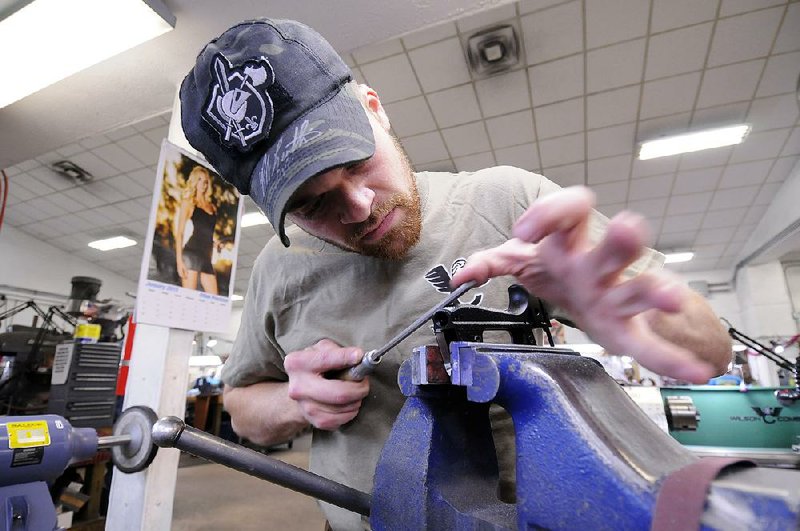 Gunsmith Jared Phillips hand checkers a Beretta 92A1 at Wilson Combat in Berryville. Beretta and Wilson Combat have paired up to create a custom-made handgun.