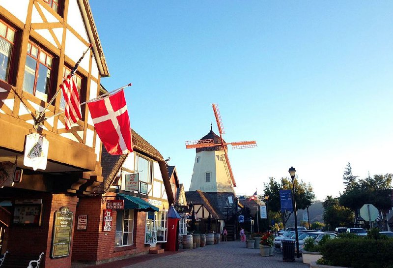 The red-and-white Danish flag flies on Alisal Road in Solvang, Calif., with a windmill in the background. Founded in 1911 by Danish immigrants, Solvang is a touristy enclave with Danish bakeries, Danish-theme hotels and even a Hans Christian Andersen Museum. 