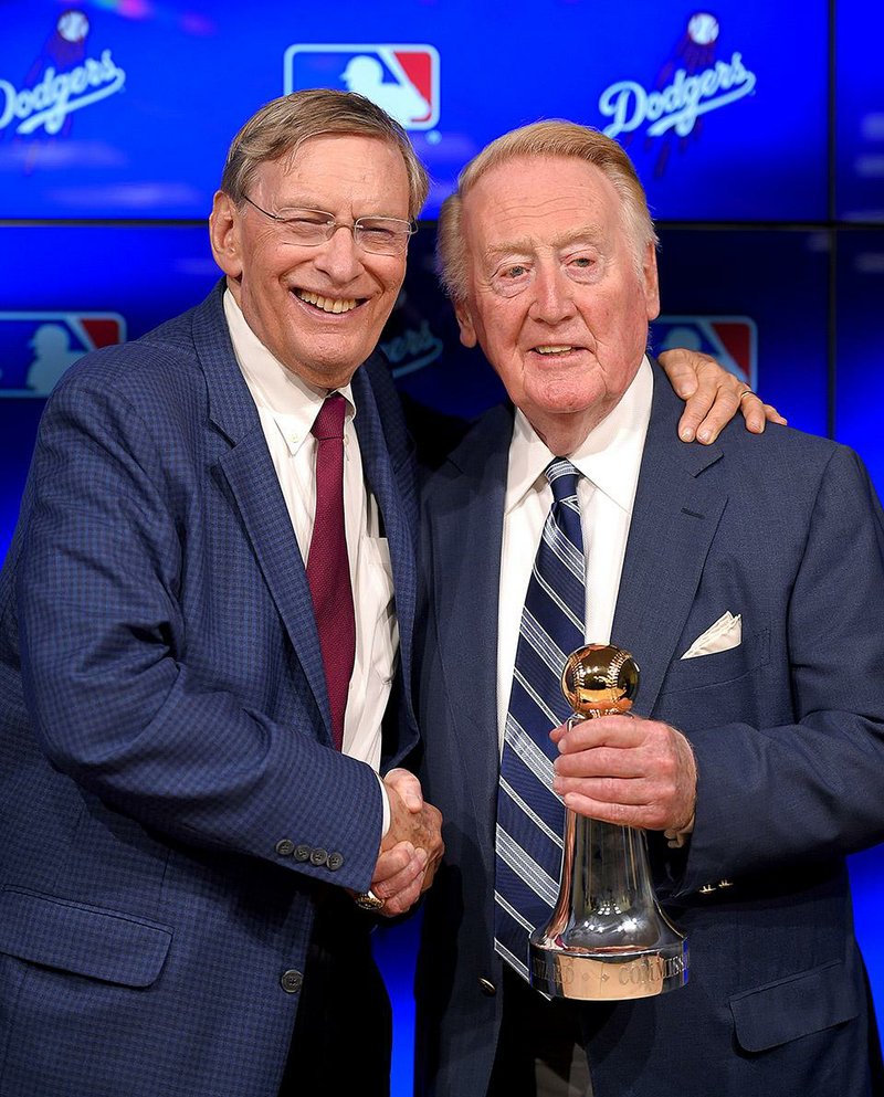 Los Angeles Dodgers broadcaster Vin Scully (right), standing with Commissioner Bud Selig, was in a state of panic when he thought he lost his 1988 World Series ring after leaving Costco in Los Angeles. Much to Scully’s surprise, his wife Sandi found it in the bottom of one of the shopping bags.