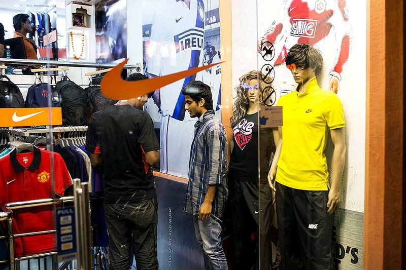 Employees chat inside a Nike Inc. store in Jaipur, India, in October. Nike reported a profit of $655 million, or 74 cents a share, in the quarter that ended Nov. 30. 