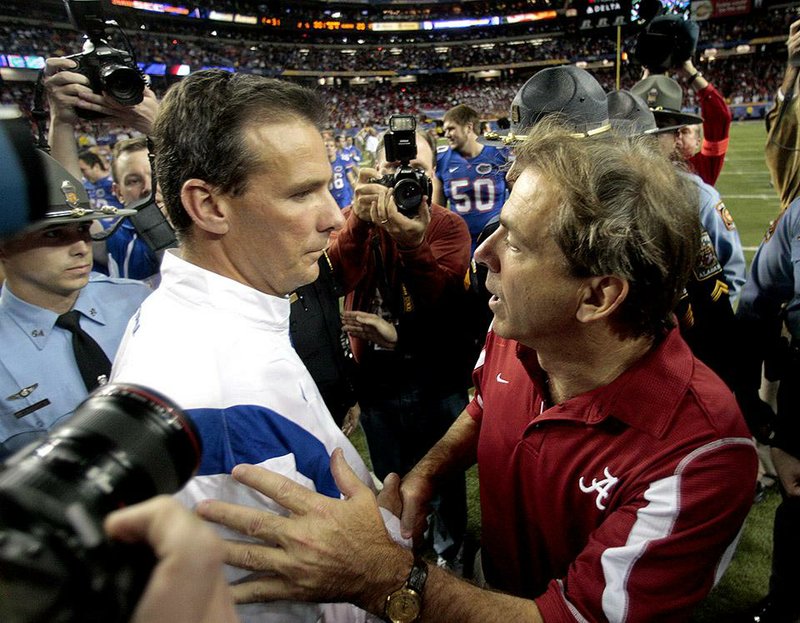 Ohio State Coach Urban Meyer (left) and Alabama Coach Nick Saban (right) haven’t met since the 2009 SEC Championship Game, but the two will renew their rivalry Jan. 1 in the Sugar Bowl in one national semifinal. 