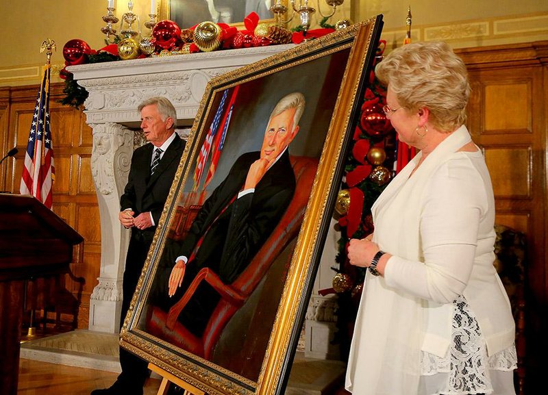 Gov. Mike Beebe and artist Ovita Goolsby unveil a portrait of the two-term governor Friday at the Capitol. “This is Arkansas talent,” Beebe said of Goolsby’s portrait. 