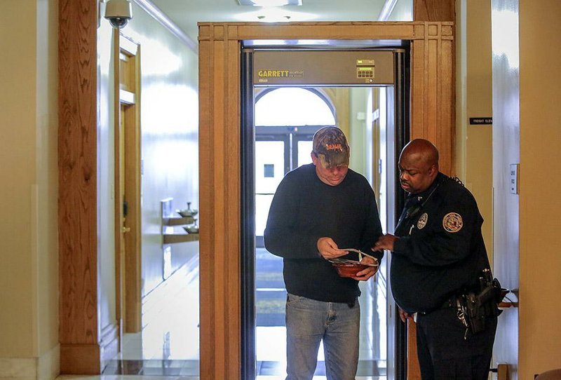 Capitol police Cpl. Adolf White gives directions Friday to William Tanner of Bigelow at the state Capitol. The Arkansas Legislative Council discussed security funding briefly during a meeting in Little Rock. 