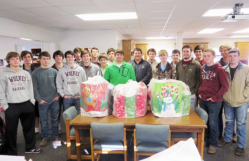 Submitted photo DOUBLE PLAY: The Lake Hamilton High School baseball team sponsored two students through Operation North Pole at the Parent Center. Coaches Seth Reeves, Donald Hurley and David Church were accompanied by the entire team when they shopped for the two students and delivered their clothes and gifts.