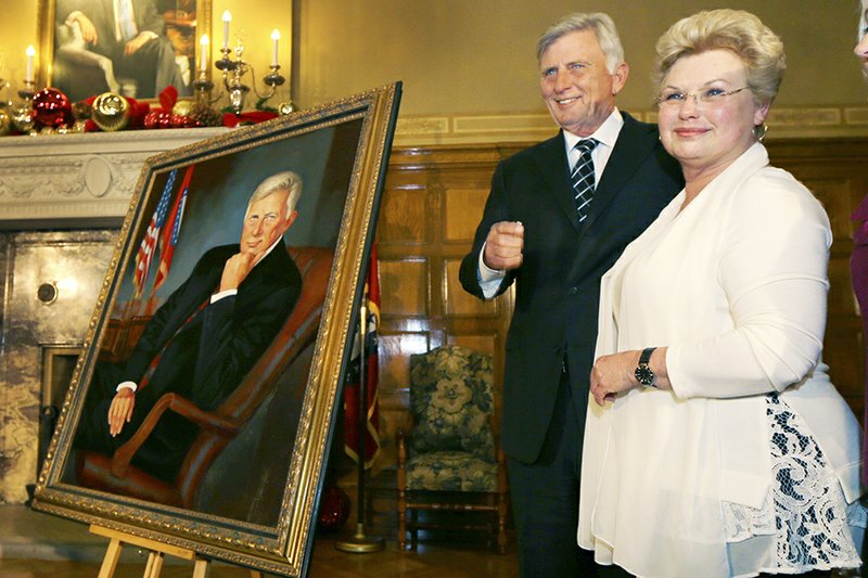 The Associated Press GOVERNOR’S PORTRAIT: Arkansas Gov. Mike Beebe, center, stands with artist Ovita Goolsby, of Royal, after her portrait of Beebe was unveiled Friday in the governor’s office at the state Capitol in Little Rock.
