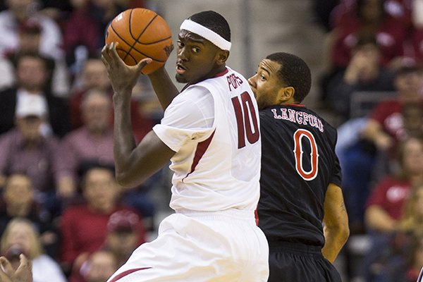 Arkansas forward Bobby Portis rebounds a basketball over SEMO guard Josh Langford during the first half of a game Saturday, Dec. 20, 2014 at Verizon Arena in North Little Rock. 