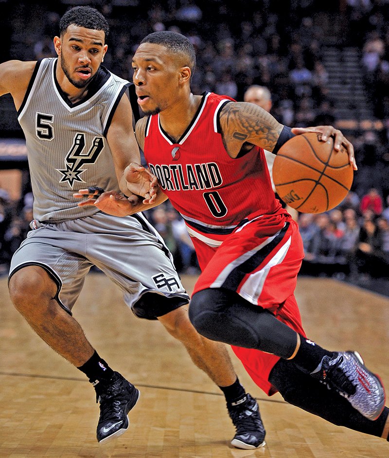 The Associated Press SAME AS THE FIRST: Portland Trail Blazers guard Damian Lillard (0) drives around San Antonio Spurs guard Cory Joseph during the second half Friday in San Antonio. Lillard scored a career-high 43 points, and Portland won 129-119 to hand the Spurs their second straight loss in triple overtime.