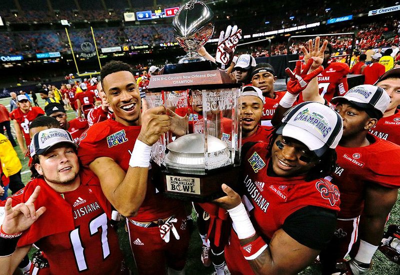 Louisiana-Lafayette players are all smiles after winning their fourth consecutive New Orleans Bowl trophy Saturday. The Ragin’ Cajuns (9-4) won their eighth consecutive game after a 1-3 start to the season, beating Nevada 16-3 at the Superdome in New Orleans.