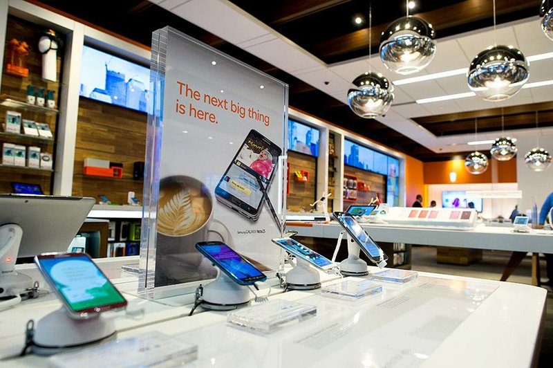 Phones and devices are displayed for sale at an AT&T Inc. store in New York, U.S., on Monday, Jan. 27, 2014. AT&T Inc. is scheduled to release earnings figures on Jan. 28. Photographer: Craig Warga/Bloomberg