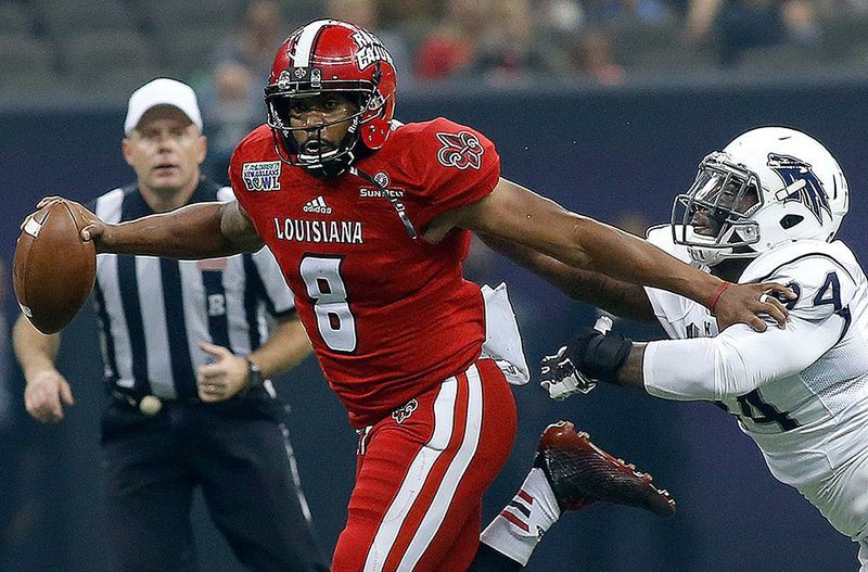 Louisiana-Lafayette quarterback Terrance Broadway tries to run past Nevada linebacker Jordan Dobrich during Saturday’s New Orleans Bowl. Broadway passed for 227 yards as the Ragin’ Cajuns won their fourth consecutive New Orleans Bowl.
