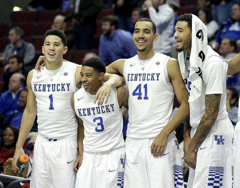 Kentucky players Devin Booker (1), Tyler Ulis (3), Trey Lyles (41), and Willie Cauley-Stein share a light moment on the sideline during their 83-42 victory over UCLA on Saturday in Chicago.