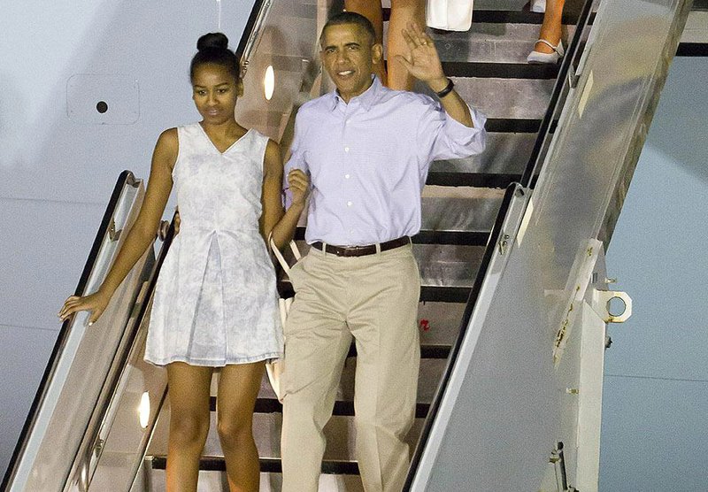 President Barack Obama and his family arrive Saturday at Joint Base Pearl Harbor-Hickam for their annual Christmas vacation in Hawaii, where Obama will consider the U.S.’ options on North Korea. 