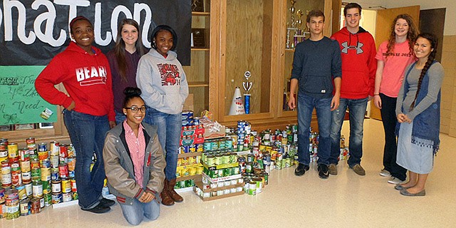 The freshmen class, represented by (from left) Kayanna Jones, Grace Basinger, Aaliyah Hardwell (kneeling), Deasia Doss, Clay Feemster, Dale Drake and Ambyer Dycus, provided the most cans with a total of 1,080 and will receive 15 minutes of extra lunch time after the holiday break. 
