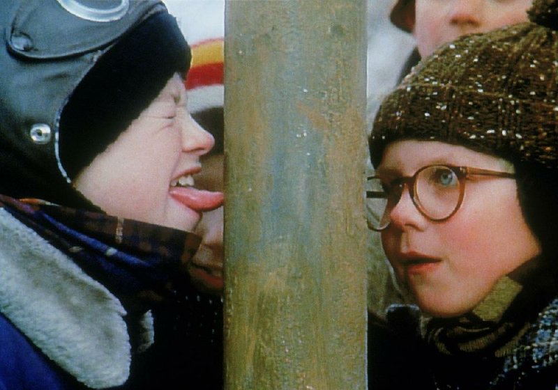 Ralphie (Peter Billingsley) watches as Flick's (Scott Schwartz) tongue gets stuck to the flagpole in Christmas Story.
