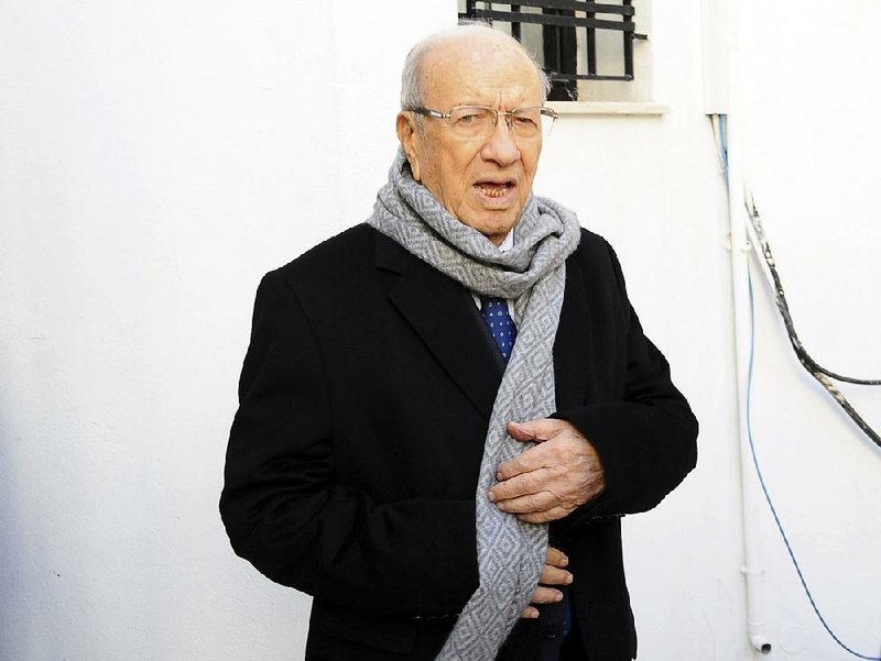 Presidential candidate Beji Caid Essebsi,  88-year-old former minister, leaves his party headquarters, Monday Dec.22, 2014 in Tunis. Newspapers in Tunisia have followed exit polls in proclaiming Beji Caid Essebsi the winner of the presidential election. Official results are expected later Monday but polls immediately after voting ended gave Beji Caid Essebsi around 55 percent of the vote.(AP Photo/Hassene  Dridi)