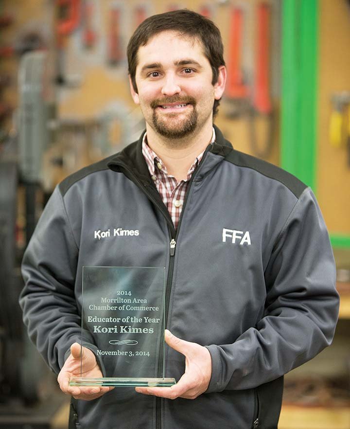 Kori Kimes, 27, holds the Educator of the Year award presented to him by the Morrilton Area Chamber of Commerce. Kimes said he feels somewhat undeserving, because there are better teachers than him. Kimes said he knew he wanted to teach agriculture after doing his student teaching under Chad Mooney in Clinton. Mooney praised Kimes as determined, goal-oriented and “a very willing learner.”