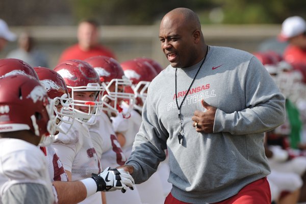Arkansas assistant coach Clay Jennings speaks to players during practice Saturday, Dec. 13, 2014, at the university's practice facility in Fayetteville.