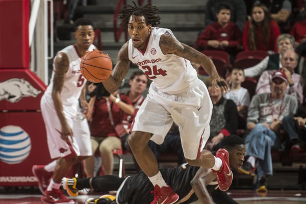 Arkansas guard Michael Qualls sprints up the court after a steal against Wisconsin-Milwaukee Monday, Dec. 22, 2014, in the second half at Bud Walton Arena in Fayetteville. The Razorbacks won 84-54.