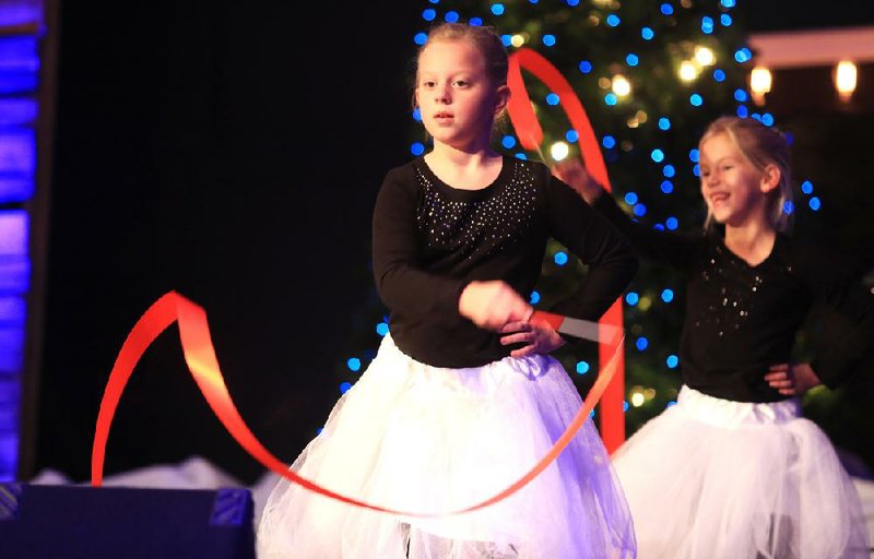 Corley Bowman, 8 (front), and Kennedy Stroud, 7, perform during the “It’s A Blue Christmas” church service Tuesday night in Little Rock. 