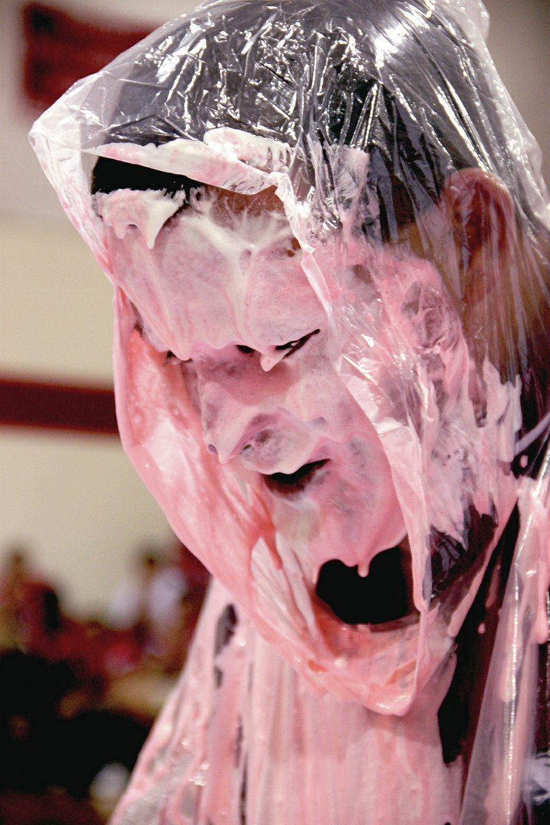 LYNN KUTTER ENTERPRISE-LEADER Farmington coach Jay Harper took a pie in the face at a pep rally Oct. 17 during a Pink Out event to raise money for breast cancer awareness. Principal Jon Purifoy and assistant principal Clayton Williams also had pies thrown into their faces.