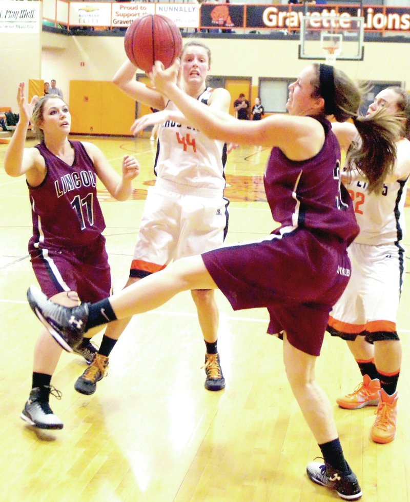 RANDY MOLL NWA MEDIA Ashtyn Rothrock kicks a leg up while jostling for a rebound against Gravette. The Lady Wolves won 61-36 on Dec. 16 to open league play with a victory.