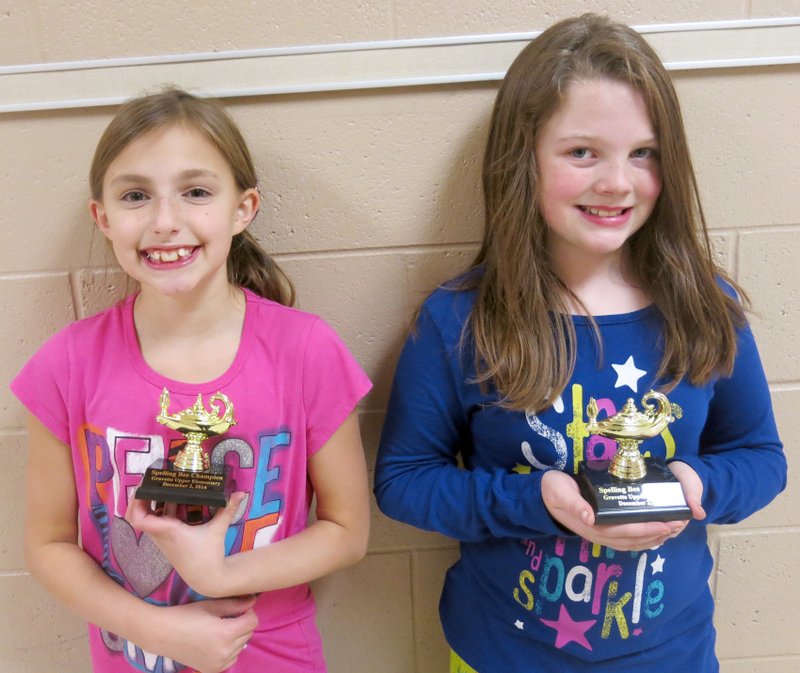 Photo by Susan Holland Winner of the Gravette Upper Elementary Spelling Bee was Alyssa Holland of Gravette (left). She is the daughter of Josiah and Heather Holland. Second place (alternate) was Hollyn Hutcheson of Gravette, daughter of Sarah and Jason Maxwell. These two girls, shown with their trophies, beat out 34 other contestants in the school spelling bee. They will compete in the county spelling bee Jan. 17 in White Auditorium at Northwest Arkansas Community College. The winner of that bee will advance to the state spelling bee at the University of Central Arkansas.