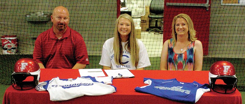 MARK HUMPHREY ENTERPRISE-LEADER Paige Purifoy (center) culminated her senior athletic career as a Farmington Lady Cardinal by accepting a scholarship offer to play women&#8217;s college softball at Crowder College, of Neosho, Mo. She was flanked by her parents, Farmington High School principal Jon Purifoy and her mother Amy, who teaches Elementary at Farmington. Paige was named Inspirational Athlete of the Year for 2014 at Farmington by the ENTERPRISE-LEADER.