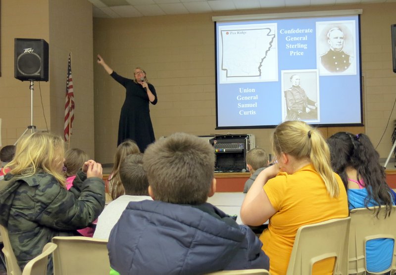 Photo by Susan Holland Fifth grade students at Gravette Upper Elementary School listened attentively as Shelle Stormoe of the Arkansas Historic Preservation Program gave her slide presentation. Stormoe spoke to the students about the importance of preserving our heritage and told them about Civil War sites and battlefields in Arkansas.