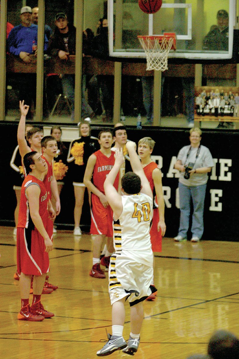 MARK HUMPHREY ENTERPRISE-LEADER Farmington center Mac Spears (far left) raises a hand signal in anticipation as McKay Gregson&#8217;s 3-point shot travels toward the goal. Cardinal Jeremy Mueller (right) rebounded a miss of McKay&#8217;s first shot and in a show of sportsmanship threw the ball back to him. McKay, a special needs player, made the 3-point shot on Valentine&#8217;s Day during a rivalry game.