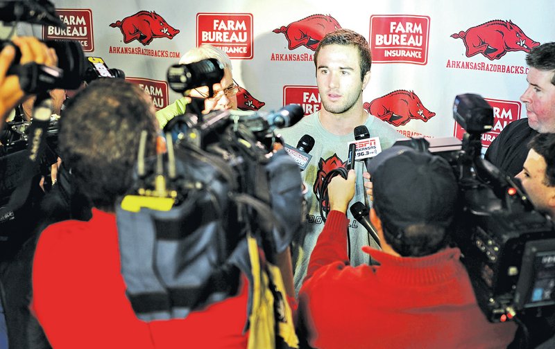  Staff Photo ANDY SHUPE Ty Storey, Arkansas quarterback, speaks to members of the media Monday during a news conference ahead of the Razorbacks&#8217; Dec. 29 bowl game with Texas in Houston. Storey has signed financial aid documents, enrolled early and is taking part in on-campus practices.