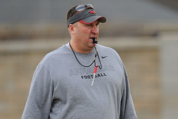 Arkansas coach Bret Bielema watches his players during practice Saturday, Dec. 13, 2014, at the university's practice facility in Fayetteville.