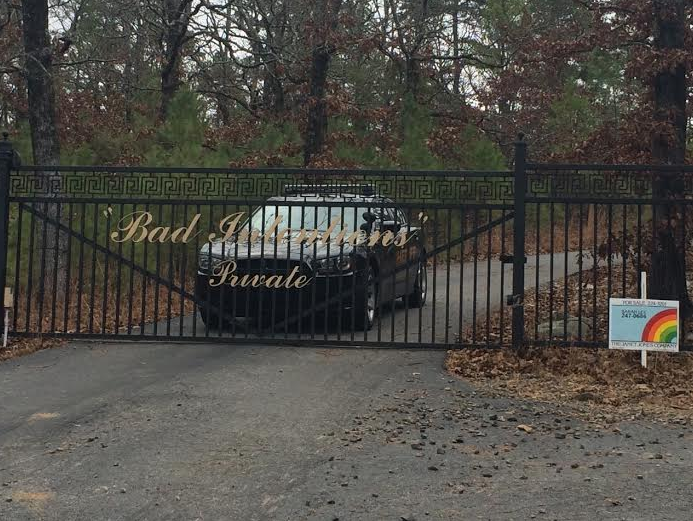 A Pulaski County sheriff's office vehicle sits behind the gate of boxer Jermain Taylor's home Wednesday morning.