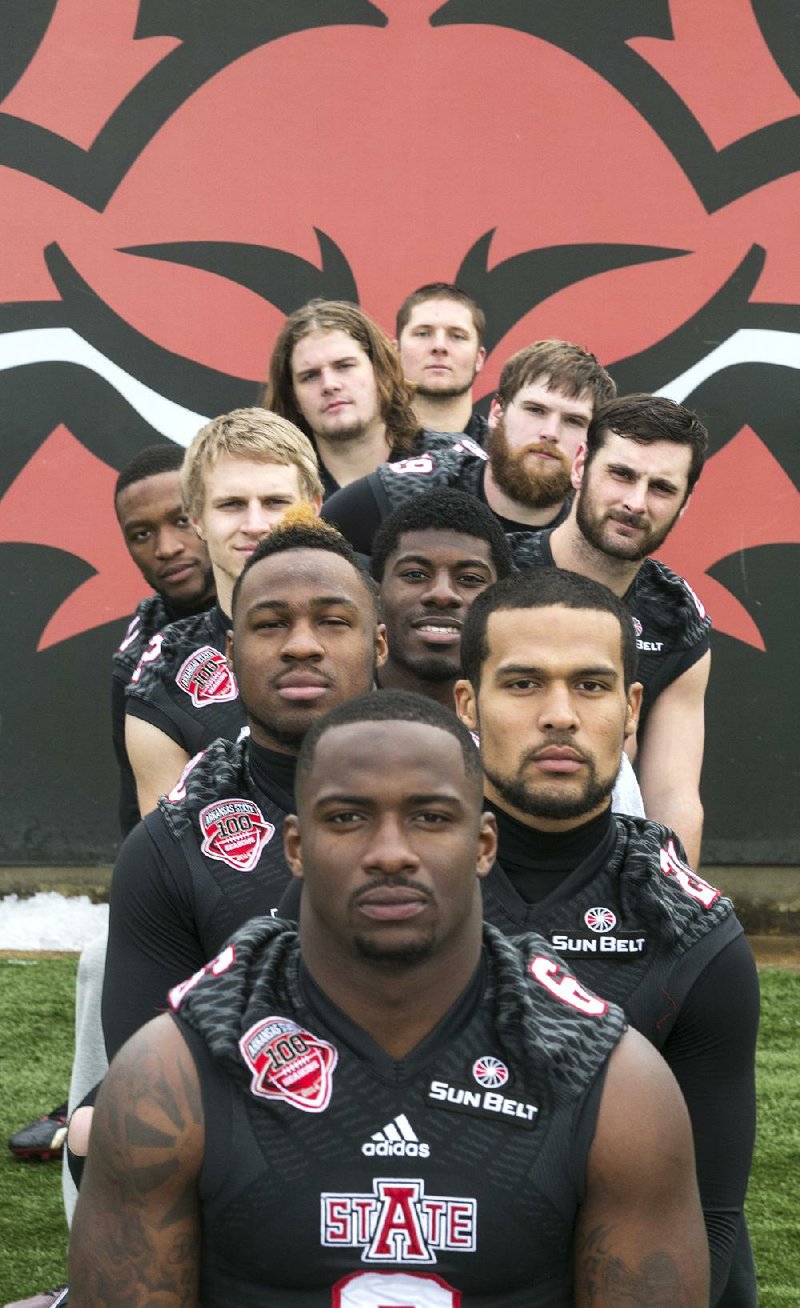 Arkansas State fifth-year seniors (front to back) Frankie Jackson, Andrew Tryon, Qushaun Lee, Ryan Jacobs, Brock Barnhill, Sterling Young (behind Barnhill), William Boyd (right of Jacobs), Alan Wright, Tyler Greve and Kenneth Rains have played for five head coaches in five seasons. The Red Wolves, led by first-year Coach Blake Anderson, will play in the GoDaddy Bowl on Jan. 4 against Toledo in Mobile, Ala. 