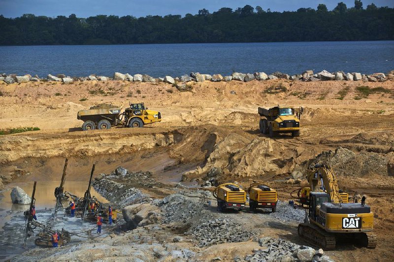 Workers use Caterpillar Inc. heavy machinery in the construction of the Belo Monte hydroelectric dam on the Xingu River in Para, Brazil, last week. 