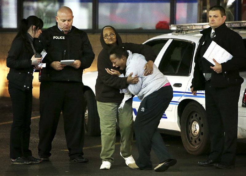 Toni Martin-Green cries out Wednesday as she talks to police at the scene where her son, Antonio Martin, was fatally shot Tuesday at a gas station in Berkeley, Mo. 