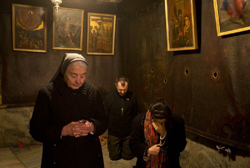 Pilgrims in the West Bank city of Bethlehem pray Christmas Eve inside the Grotto of the Church of the Nativity, traditionally believed by Christians to be the birthplace of Jesus. Outside, the atmosphere was festive as thousands flocked to the biblical town. 